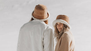 Man in wintery mountain snowscape wearing a Will & Bear hat