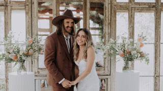 A couple at sunset wedding ceremony wearing Will & Bear hat