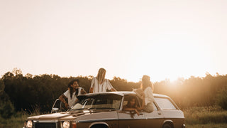 Friends gather by a car at sunset, wearing Will & Bear felt hats, radiating a carefree vibe.
