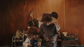 Two young kid with camping gear wearing kids brown camping hats by Will & Bear