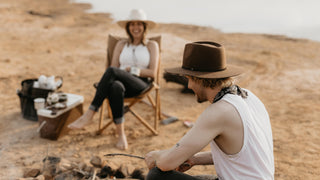 A solitary Akubra style hat floating against a dark background, symbolizing the outback spirit.