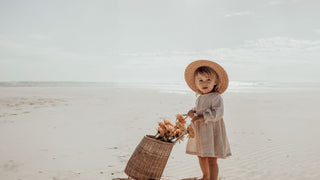 Children on a car hood enjoy coconuts, wearing Will & Bear summer hats, sharing laughter.