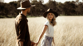 Assortment of brown hats by Will & Bear stylishly hung on a white wall.