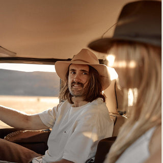 Man sitting inside 4WD wearing Anderson Cream hat, candid road trip moment