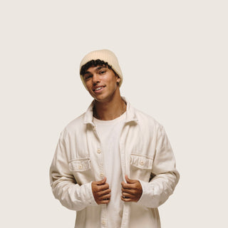 Man wearing the Will & Bear Bambi Custard yellow merino wool beanie paired with a white shirt, minimal and modern.