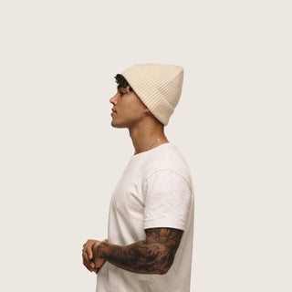 Profile view of man wearing the Will & Bear Bambi Custard beanie, a lightweight yellow wool beanie for everyday comfort.