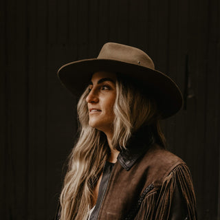 Woman wearing Will & Bear Wide Brim Country Hat with a fringed jacket, styled for Western-inspired outdoor wear.