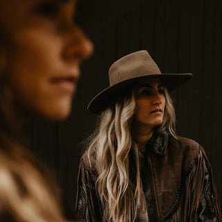 Woman in profile wearing a Will & Bear Wide Brim Country Hat, styled with long hair and an outdoors jacket.