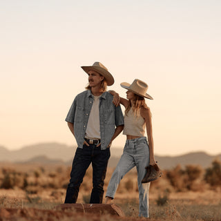 Couple walking through the outback wearing Will & Bear white cowboy hats made from Australian wool felt.