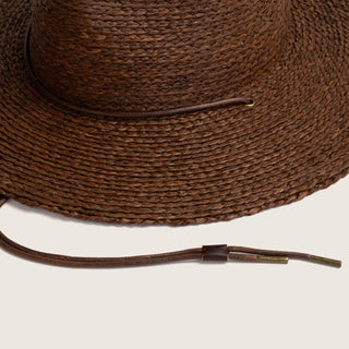 Close-up image of Will & Bear Brown Straw Wide Brim Hat Austin Brown showing leather chin strap and fine woven detail