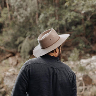 Man exploring outdoors wearing Will & Bear Brown Country Hat, perfect for rugged adventures