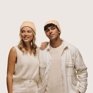 Couple wearing matching Will & Bear Bambi Apricot merino wool beanies, highlighting unisex style and cosy fit.