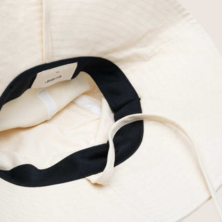 Inside view of Will & Bear Kids Packable Bucket Hat showing sweatband, stitching, and adjustable chin strap.