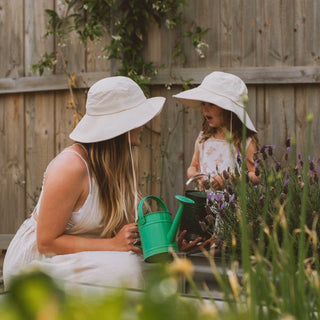 Mother and child wearing Will & Bear Kids Packable Bucket Hats while gardening, showcasing full sun coverage and natural materials.