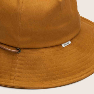 Close-Up Detail of Will & Bear Kids String Bucket Hat – Chin Strap and Logo Tag in Rust Orange Colour.