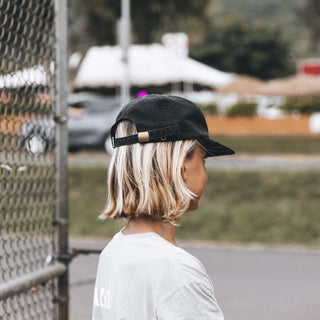 Side Profile of Child Wearing Will & Bear Kids Black Cap – Sun-Safe and Comfortable Cap for Everyday Wear.
