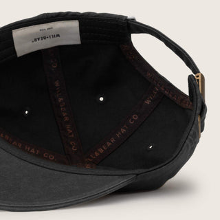 Inside View of Will & Bear Kids Black Cap – Quality Cotton Construction with Internal Stitching Detail.