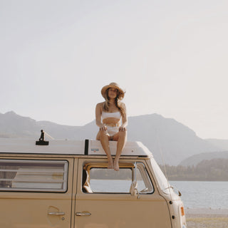 Woman in Will & Bear Crushable Straw Bucket Hat standing in open van door, ready for summer escapes