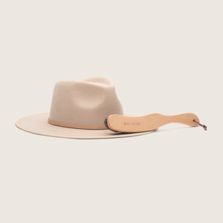 Will & Bear Hat Brush placed next to a wool hat, highlighting ideal storage and hat care pairing.