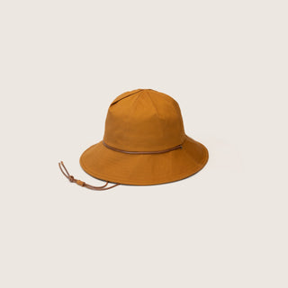 Will & Bear Lenny Rust Orange Bucket Hat on neutral background, featuring wide brim, dome crown, and adjustable chin strap.