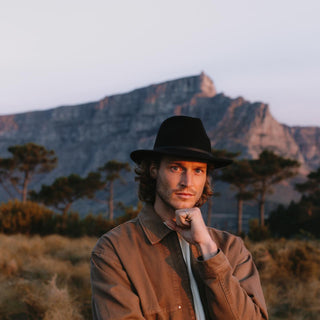 Solo male wearing Will & Bear William Black fedora – the crushable wool hat perfect for travel, adventure, and everyday wear.