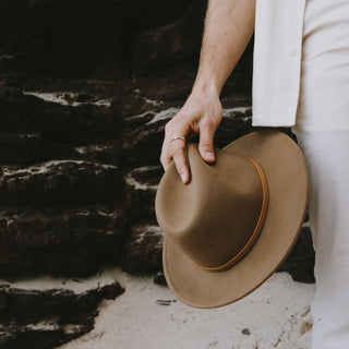Will & Bear William Oak light brown fedora hat being held – natural, unisex design ideal for packable travel adventures.