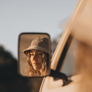 Woman in Will & Bear Perry Bone Beige Cord Bucket Hat – Coastal Travel Moments on the Road.