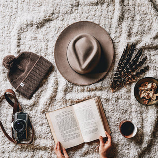 Will & Bear Brown Pom Pom Beanie – Tasman Brown – laid flat with camera, coffee, and journal – perfect for slow mornings.