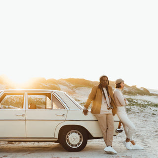 Woman and man leaning on a vintage car, both wearing the Will & Bear Doc Fawn Wool Fisherman’s Beanie.