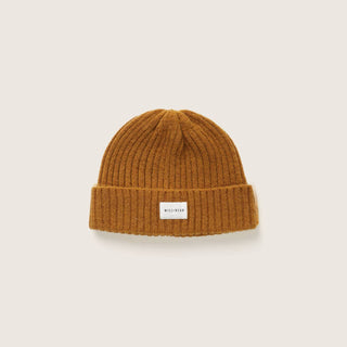 Upright view of the Will & Bear Levi Mustard Wool Beanie, showing folded cuff and warm yellow tone.