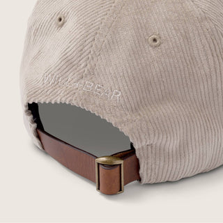 Detail of Will & Bear Parker Bone Beige Cord Dad Cap – Brass Adjustable Strap and Embossed Logo.