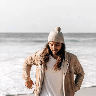 Man in Will & Bear Soft Wool Beanie – Tasman Fawn – walking the coast, made for slow mornings and ocean air.
