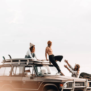 Group wearing Will & Bear Soft Wool Beanie – Tasman Fawn – embracing adventure, warmth, and coastal travel vibes.