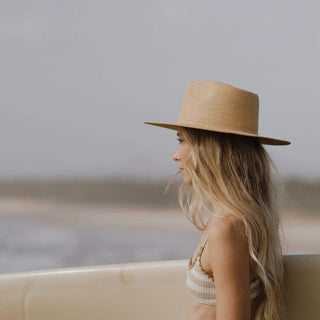 Woman wearing Will & Bear Wide Brim Straw Hat – Sawyer Sand – sun-safe headwear for coastal adventures.