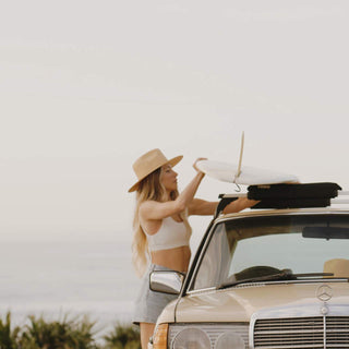 Woman wearing Will & Bear Wide Brim Straw Hat – Sawyer Sand – adventure-ready hat for surf, sun and saltwater living.