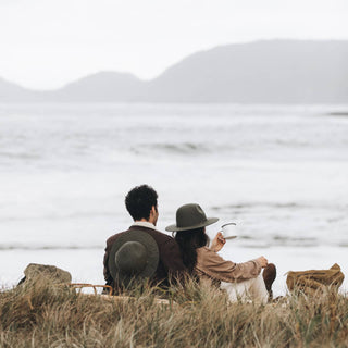 Couple Wearing Will & Bear Woodley Moss Felt Gardening Hats with Dog by the Ocean – Outdoor Adventure Hats