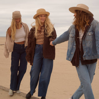 Three girls wearing hats at the beach