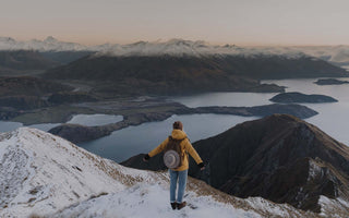 Person on mountain with hat travel bag clip