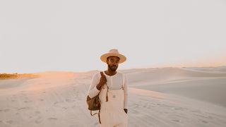 Man walking in the desert wearing a Andy hat by Will & Bear