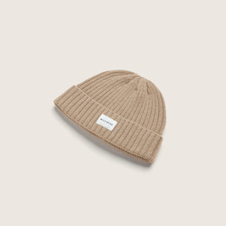 Light cream or beige beanie in studio