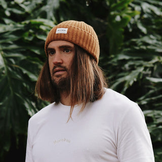 Man wearing wool beanie and organic and recycled cotton t-shirt