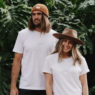 Man and woman wearing recycled and organic cotton t-shirt with wool beanie and hat