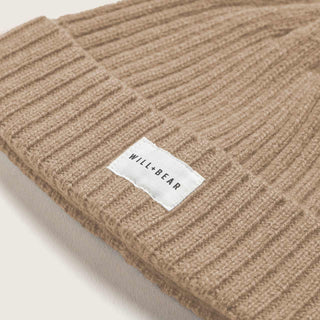 close up studio shot of beige cream beanie