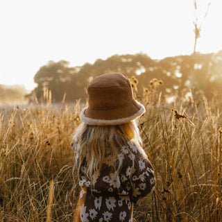 little girl wearing the ugg wool bucket hat