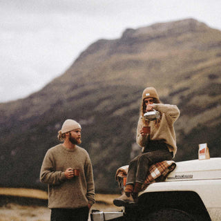 Man and women hanging by the car wearing Australian ribbed wool beanie having a cup of tea