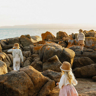 Kids climbing rocks wearing the ugg wool bucket hat