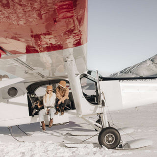 two women wearing the ugg wool bucket hat sitting in a plane