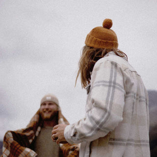 two men wearing wool beanies