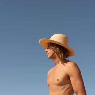 Man wearing rustic straw beach hat Jude Sand in full sun by Will & Bear