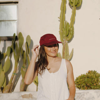 Woman wearing the Archie Maroon Cap